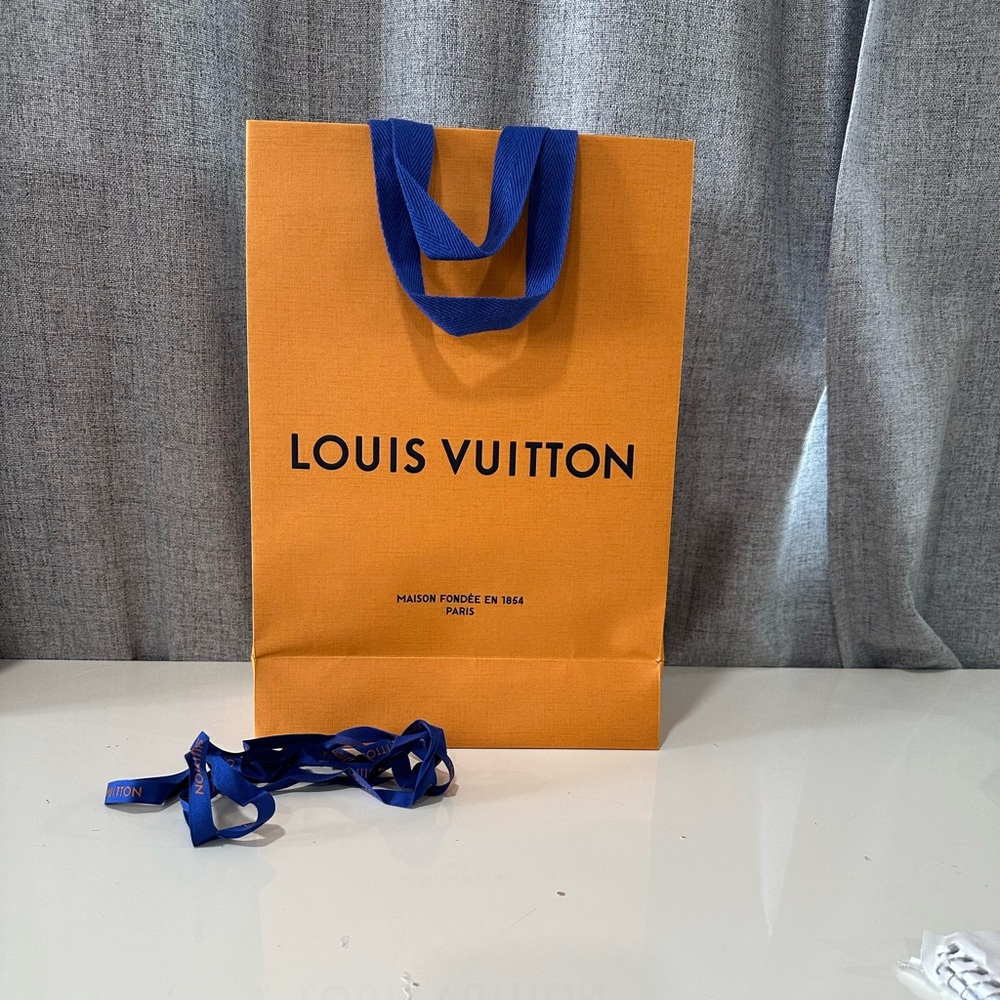 Authentic Louis Vuitton orange empty shopping bag.